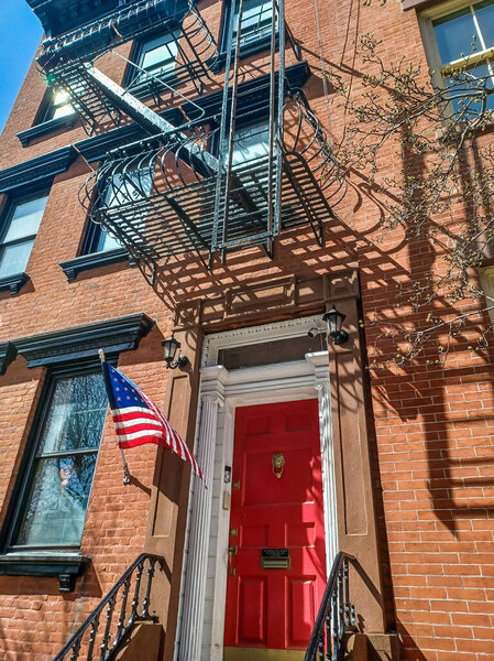 Apartment building in new york city with flag of USA