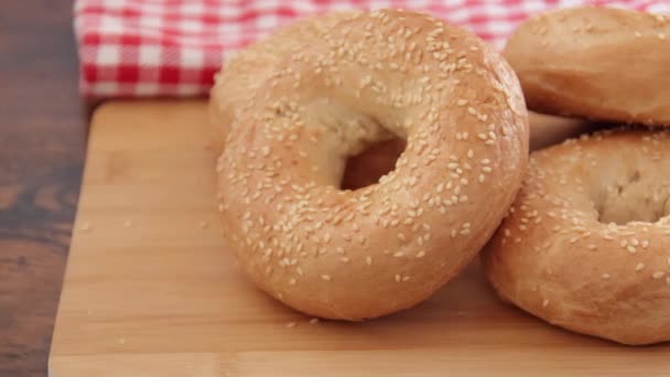 Fresh Baked Bagels Sesame Seeds Wooden Background Video — Stockvideo