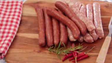 close up of merguez sausages on wooden board