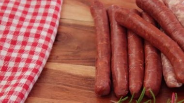 close up of merguez sausages on wooden board