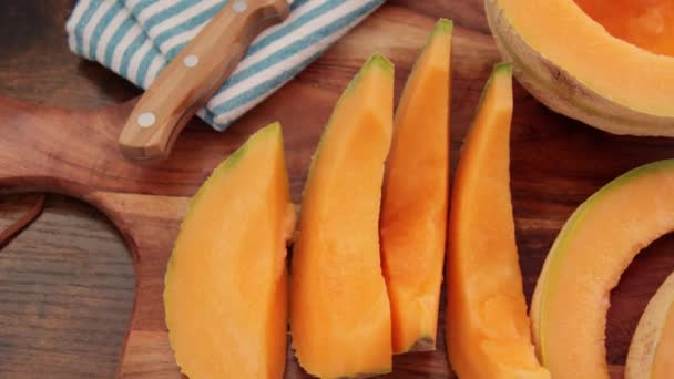 Fresh Ripe Sliced Melon Wooden Background — Stock Video