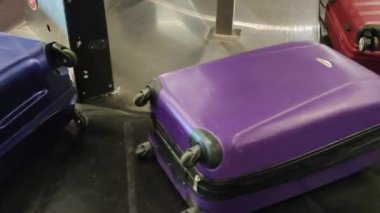 close up of suitcases on baggage carousel
