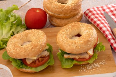 bagels with chicken and raw vegetables, close-up