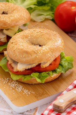 bagels with chicken and raw vegetables, close-up