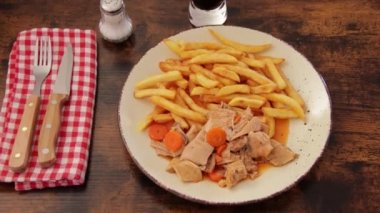 plate of tripe and fries close up