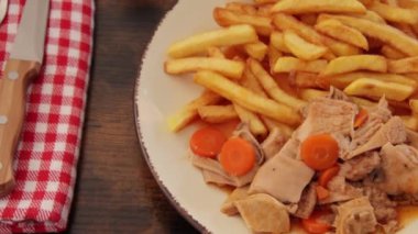 plate of tripe and fries close up