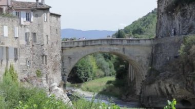 view of the Roman bridge in the city of Vaison-la-Romaine in summer