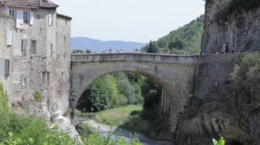 view of the Roman bridge in the city of Vaison-la-Romaine in summer