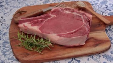 raw rib of beef on cutting board