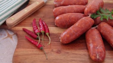small raw chorizo sausages on a cutting board