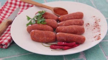 small raw chorizo sausages on plate