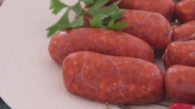small raw chorizo sausages on plate