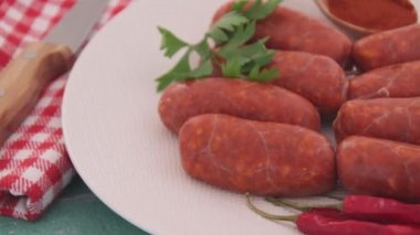 small raw chorizo sausages on plate