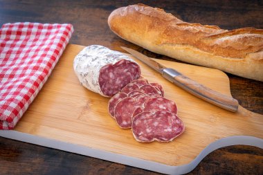 sliced dry sausage, bread, cheese and pickles