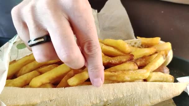Άνθρωπος Τρώει Χοτ Ντογκ Τηγανητές Πατάτες — Αρχείο Βίντεο