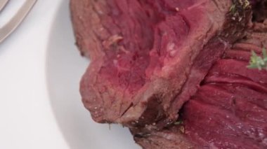 Tabakta az pişmiş biftek dilimleri.