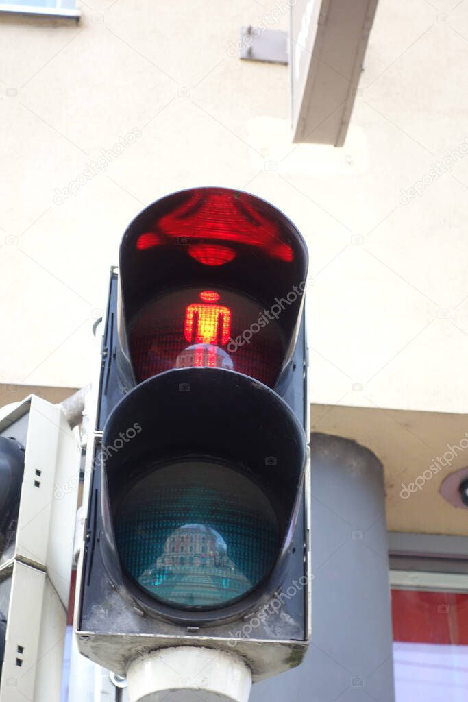 red pedestrian traffic light on the street, visual signal for road users