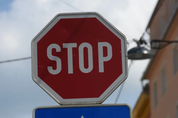 red stop sign in traffic, signaling the driver to completely stop