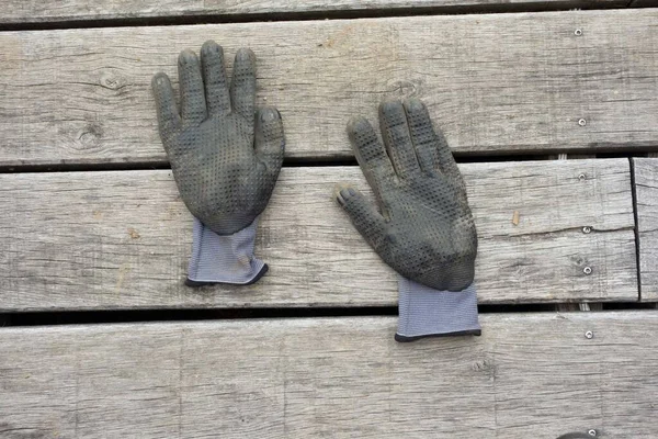 person working with gardening gloves in the garden, gardening as a leisure activity