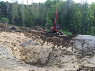 İnşaat alanında kazıcı, toprak işçiliği ve inşaat projesi için ağır makineler.
