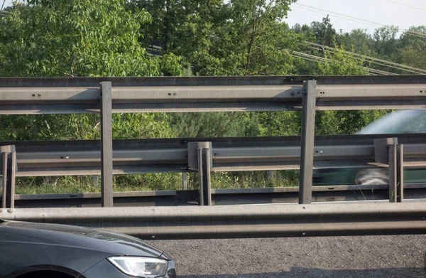 a guard rail or a crash barrier on a highway
