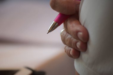 writing with a writing pen, writing down stories and notes