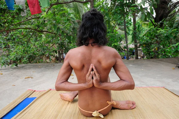 pashchima namaskarasana or reverse prayer pose, an exercise in yoga