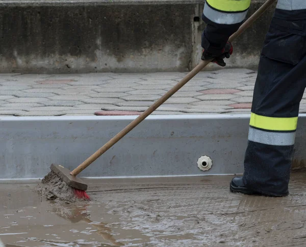 floor cleaning with a broom, sweeping away the dirt and dust