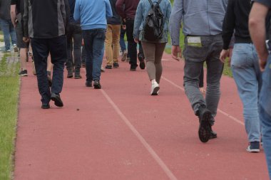 Bir grup insan birlikte, bir etkinliği izliyorlar.