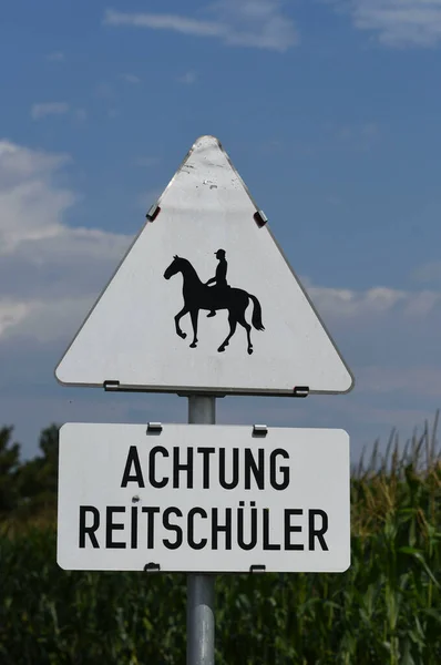 horseback riding sign, sport and recreation, outdoor activity with a horse