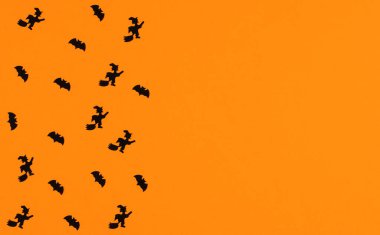 Turuncu arka planda yarasalar ve cadılar. Metin için yeri olan Cadılar Bayramı arkaplanı.