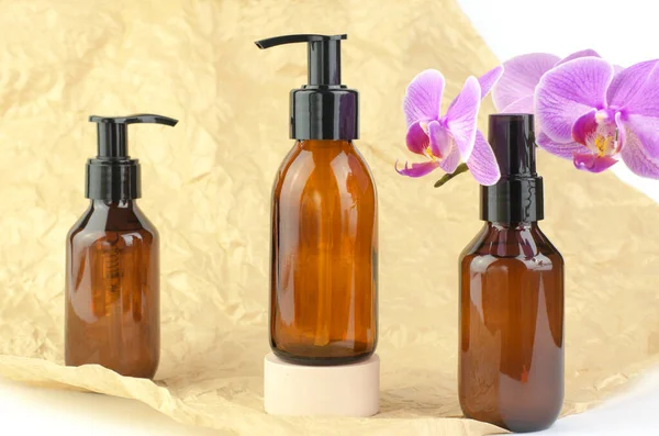 Presentation of cosmetic products. Brown cosmetic bottle on a colored background.