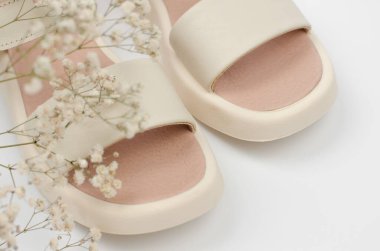 Stylish women's sandals on a white background, close-up