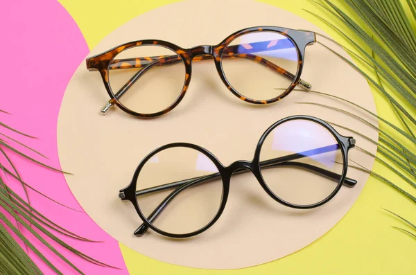 Stylish Women Eyeglasses Colored Background Palm Leaves Stockfoto