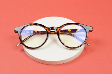 Yuvarlak bir kürsüde şık gözlükler. Leopar gözlükleri.