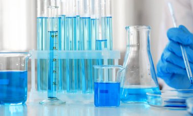 Laboratory clinical trials. Laboratory pipette in the hands of a scientist. A scientist conducts research on a vaccine against coronavirus.