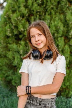 Portrait of a 12 year old red-haired teenage girl in nature