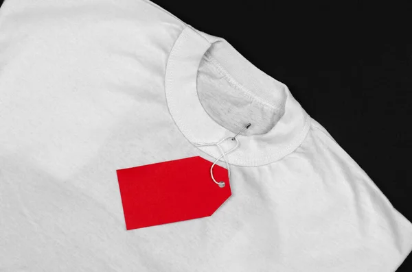 Shirt Branca Sobre Fundo Preto Com Uma Etiqueta Branco Vermelho — Fotografia de Stock