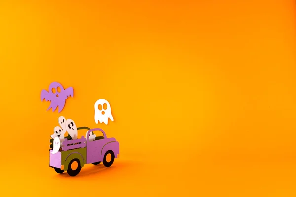 Happy halloween holiday concept. Halloween handmade paper decorations, spiders, ghosts in car on orange background. Halloween festival party, greeting card mockup with copy space