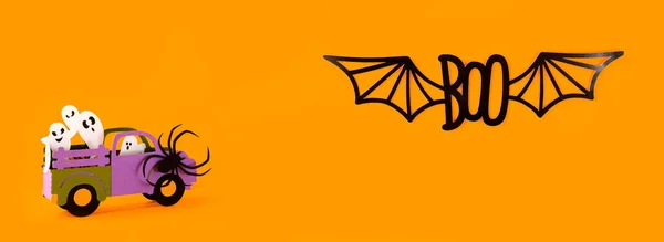 Happy halloween holiday concept. Halloween handmade paper decorations, spiders, ghosts in car, bats, boo text on orange background. Halloween festival party, banner, card mockup with copy space