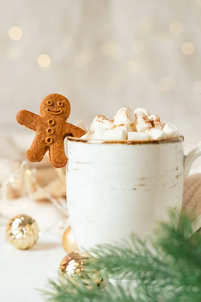Gingerbread man cookie in cup of hot cocoa or coffee with marshmallow, fir tree, cinnamon and warm cozy sweater. Christmas banner, lights background. Xmas holiday decorations with copy space — Stock Photo, Image