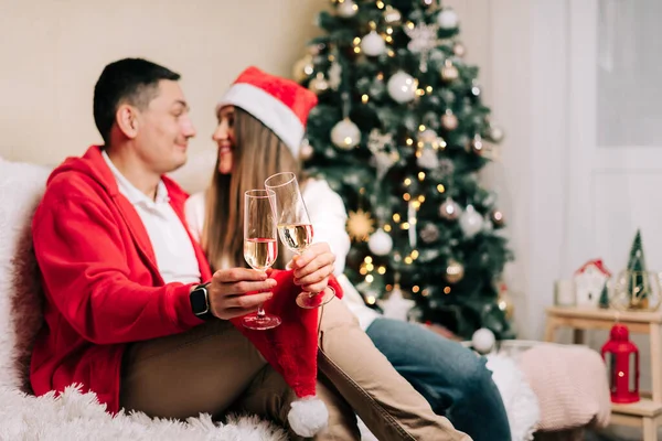 Family couple with funny face, man and woman with champagne celebrate New year after Christmas holidays. Home decor with Christmas tree — Stock Photo, Image