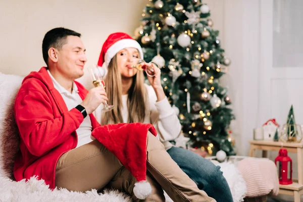 Family couple with funny face, man and woman with champagne celebrate New year after Christmas holidays. Home decor with Christmas tree — Stock Photo, Image