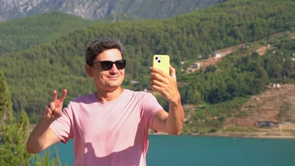 Man Taking Selfie Mobile Phone Mountains Lake Background Traveler Male — Vídeo de Stock