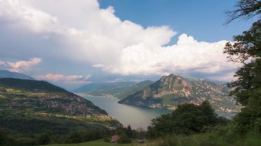 Timelpase at Lake Iseo and Mount Corna Trentapassi at sunny day with clouds. Bergamo, Lombardy, Italy.