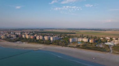 Timelapse of typical adriatic beach with umbrellas and gazebos, background  Lido Adriano town, Ravenna, Italy.