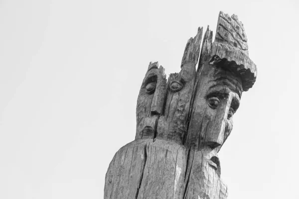 Toy wooden sculpture of a sage in the park