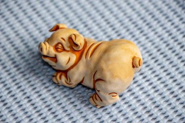 A small toy children\'s sculpture of a piglet