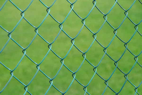 Green metal mesh and lawn on the football field