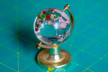 Masanın üzerindeki camdan yapılmış oyuncak küre.